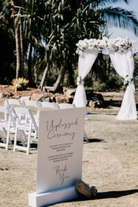 Professional videography outdoor wedding ceremony setup with arch