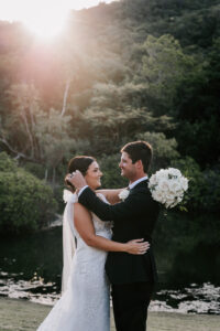 Professional videography couple embracing in scenic outdoor setting