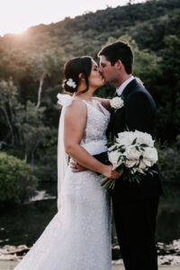 Professional videography wedding couple kissing by serene lake