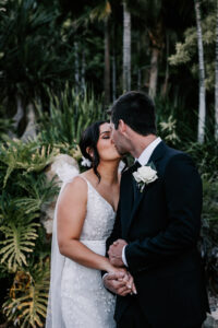 Professional videography photo of a couple's scenic wedding kiss