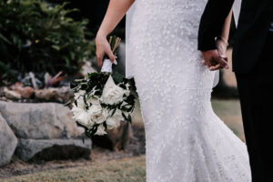 Professional videography capturing wedding couple with bouquet