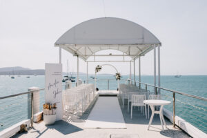 Professional videography wedding setup by the sea with chairs