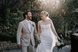 Professional videography at outdoor wedding with happy couple