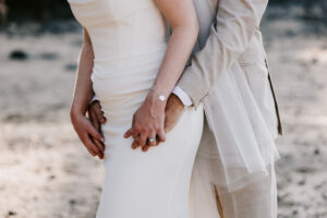Professional videography wedding couple embrace on beach