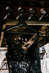 Professional videography, photography, ornate black dress hanging