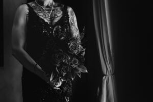 Professional videography of person holding bouquet in black dress