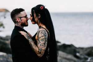 Professional videography, photography, and drone footage couple embracing by the sea