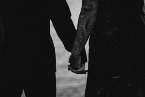 Professional videography, photography, couple holding hands by water