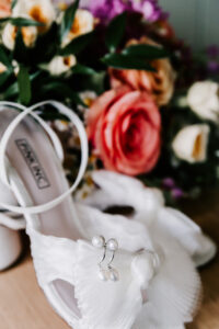 Professional videography wedding shoes and floral arrangement