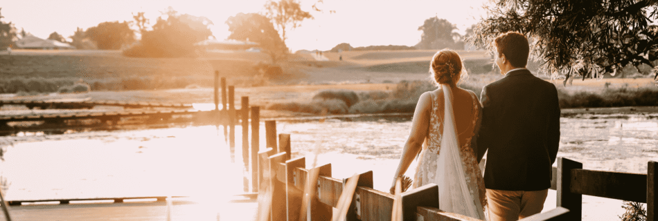 Professional videography, photography, and drone footage of sunset lake wedding couple