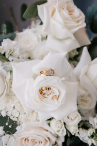 Professional videography photography drone footage of wedding rings on roses