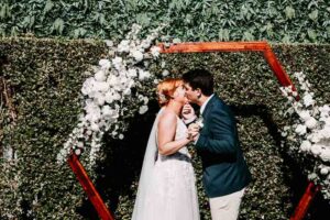 Professional videography, photography, and drone footage, wedding couple kiss.