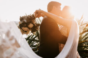Professional videography wedding couple embrace at sunset