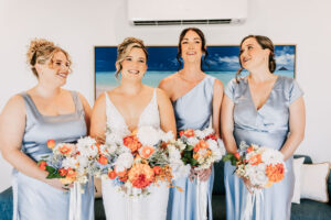 Professional videography wedding bridesmaids smiling with bouquets