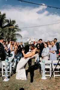 Professional videography captures romantic outdoor wedding kiss
