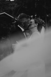 Professional videography photography and drone footage wedding kiss