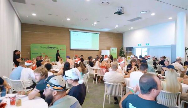 Professional videography, photography, and drone footage capture event gathering in modern conference room