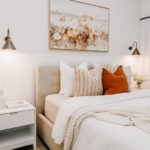 Styled bedroom with layered bedding and bedside lamps