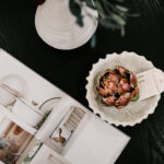 Coffee table styling with an open book and decorative bowl