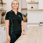 The Stylist standing beside a timber kitchen bench