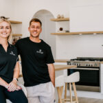 The Stylist team portrait beside a kitchen island
