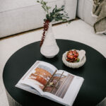 Living room coffee table with a book and vase