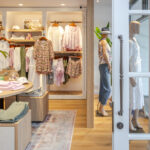 Professional videography, photography, and drone footage of chic boutique interior with clothing display