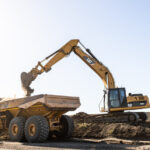 Professional videography of construction excavator and dump truck