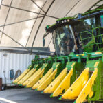 Professional videography capturing large green farming equipment