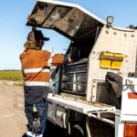 Professional videography with field equipment and utility truck.