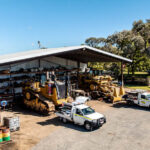 Professional videography drone view of industrial machinery yard