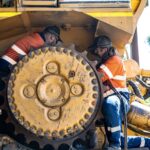 Professional videography drone footage workers fixing machinery