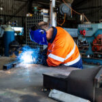 Professional welder working in an industrial workshop setting
