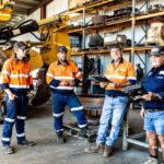 Professional videography and photography team in industrial setting