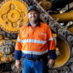 Professional videography photographer with industrial machinery