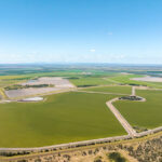 Professional videography of sprawling green fields and roads