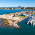 Professional videography coastal marina aerial view vibrant blue water