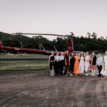 Professional videography and photography by a red helicopter