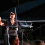 Professional videography capturing event speaker by aircraft