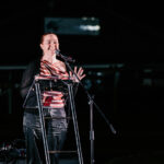 Professional videography speaker on stage at night event