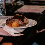 Professional videography captures elegant dining with gourmet steak