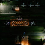 Professional videography photography drone shot of aircraft at night
