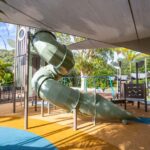 Professional videography of an outdoor spiral playground slide