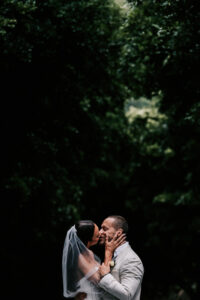 Professional videography romantic couple kiss in forest setting