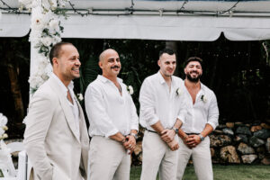 Professional videography wedding groomsmen in light attire