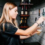 Professional videography capturing bartender pouring draft beer