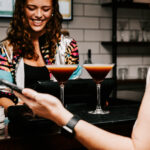 Professional videography smiling bartender serving cocktails
