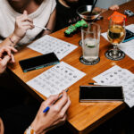 Professional videography group playing bingo at a wooden table