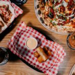 Professional videography, photography, and drone footage of a delicious meal spread on a wooden table