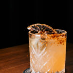 Professional videography cocktail glass with garnish on table